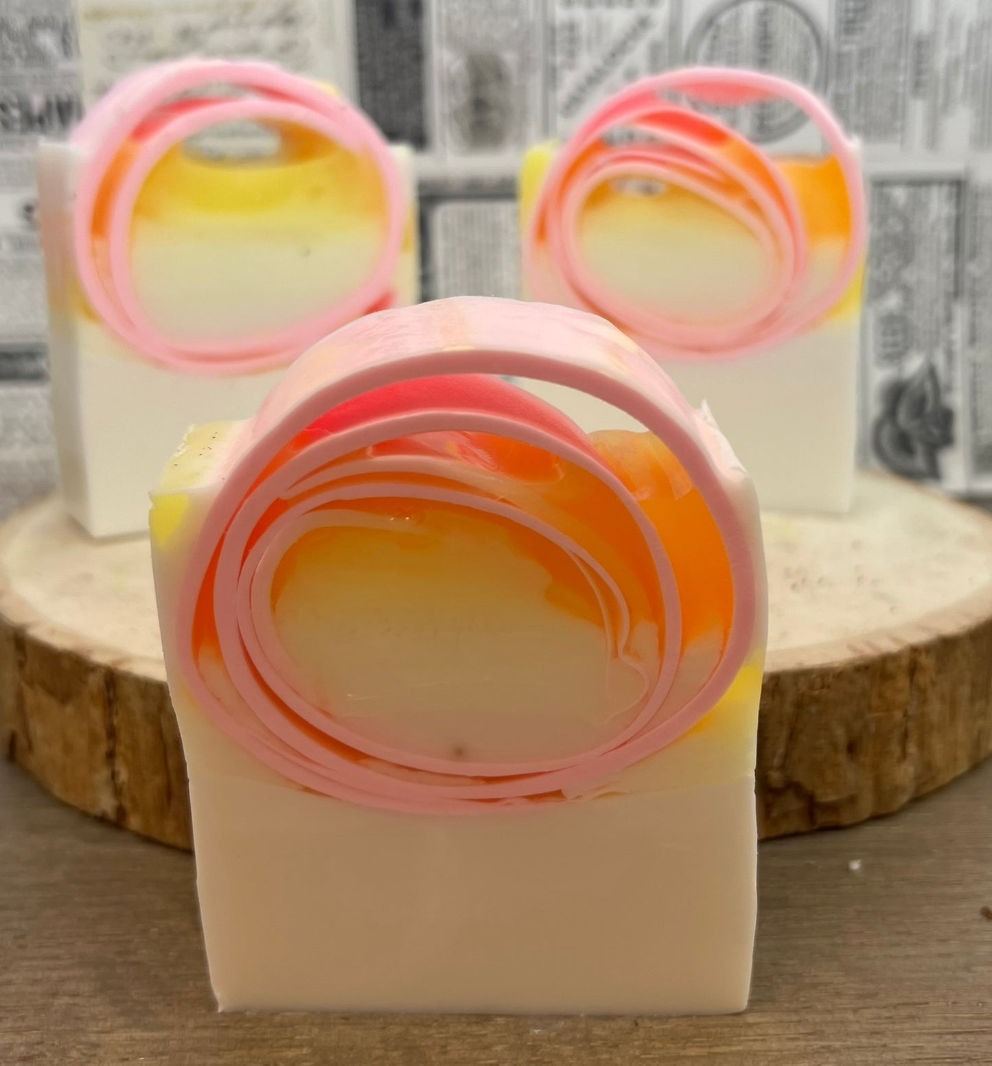 Pink grapefruit goat milk soap from The Bubble Bath Shop, showing a creamy soap bar with pink grapefruit slices.