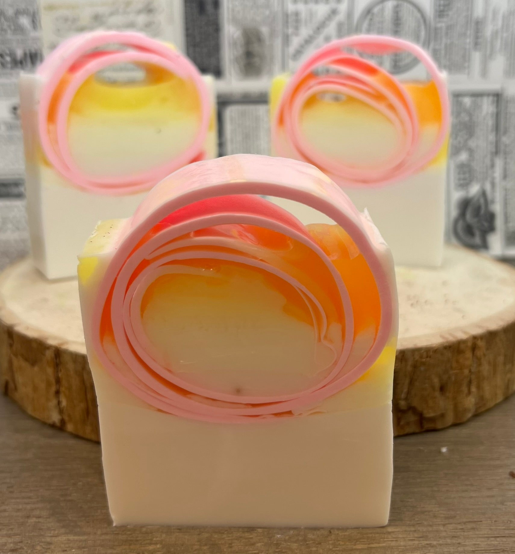 Pink grapefruit goat milk soap from The Bubble Bath Shop, showing a creamy soap bar with pink grapefruit slices.
